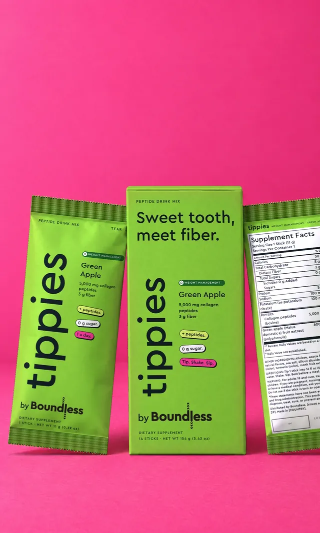 A green apple tippies Weight Management box and drink mix stick on a pink background